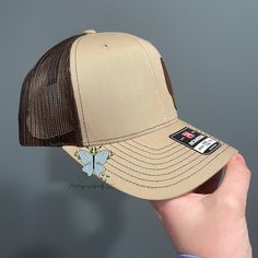 Gear up for your next outdoor adventure with our Morel Mushroom Leather Patch Richardson 112 Hat/Cap. The genuine leather patch adds a touch of rustic charm, while the adjustable strap ensures a comfortable fit. Show off your love for the great outdoors with this stylish and functional hat! The leather patch designs are affixed with adhesive for very secure attachment to the hat. Due to monitor colors, patches and hat colors may be slightly different in person. Custom leather patch hats are made Brown Trucker Hat With Logo Patch For Outdoor, Brown Trucker Baseball Cap For Camping, Trucker Style Brown Baseball Cap For Camping, Brown Trucker Hat For Camping, Beige Flat Bill Trucker Hat For Outdoor, Country Style Brown Baseball Cap With Flat Brim, Western Style Brown Trucker Hat For Outdoor, Rugged Brown Hat For Outdoor Activities, Brown Flat Brim Country Baseball Cap