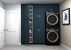 a washer and dryer in a laundry room with blue cabinets on the wall