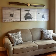 a living room with a couch and two paintings on the wall next to each other