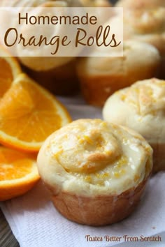 some oranges and muffins are sitting on a napkin with the words homemade orange rolls