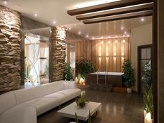 a living room filled with white furniture next to a stone wall and planters on the walls