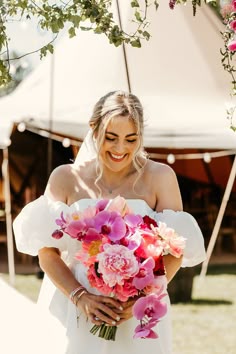 Laughing bride holding bright pink bouquet with orchids and roses White And Pink Orchid Bouquet, Blush Wedding Dress With Bouquet, Floral Wedding Dress With Bouquet, Round Bride Bouquet, Peony And Orchid Wedding Bouquet, Bright Bride Bouquet, Green White And Pink Wedding Flowers, Florida Wedding Bouquet, Wedding Flower Orchid