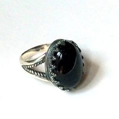 "My first love Amazing silver ring. A great combination of the deep black onyx set in the oxidized silver bezel. (R2058). © 2011-2015, Artisanimpact Inc. All rights reserved. Construction & Dimensions: Sterling silver, onyx. Approximate band width: 3mm - 10mm Top part of the ring 15mm (0.59\") x20mm (0.78\"). We can make any size, including quarter sizes. Please just indicate the requested size in the order. About our jewelry Artisanlook offers an exciting collection, designed and made by ar Unique Ring With Large Stone, Handmade Classic Sterling Silver Crystal Ring, Classic Adjustable Rings With Stone Setting, Spiritual Cabochon Rings For Anniversary, Spiritual Birthstone Ring For Formal Occasions, Elegant Handmade Dome Ring For Promises, Unique Formal Birthstone Rings, Anniversary Spiritual Cabochon Rings, Sterling Silver Cabochon Wedding Rings