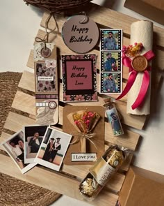 a wooden table topped with lots of different types of cards and pictures on top of it