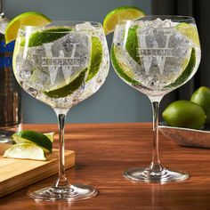 two glasses filled with ice and limes