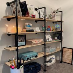 a room with several shelves and pictures on the wall