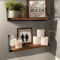 two wooden shelves above a toilet in a bathroom