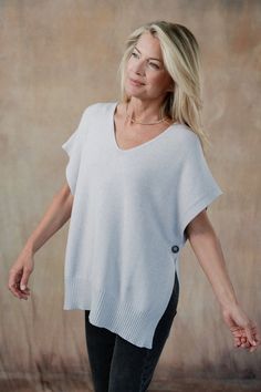 Elevate your layering game with the Devyn Vest, a versatile essential that adds a touch of charm to any outfit. A lightweight cami, collared shirt, or romantic blouse would benefit from this essential topper, designed to mix-and-match with our coordinating Cleo Sweater Pants. Part of our Mix-and-Match Knitwear capsule. Classic fit. One size fits most. Short sleeve, open-side sweater with mother-of-pearl button closure, ribbed hemline. Italian knit blend. Hand wash cold, lay flat to dry. Made in Romantic Blouses, Italian Leather Bags, Romper And Jacket, Feminine Blouses, Denim Joggers, Italian Outfits, Sweater Pants, Collared Shirt, Mother Of Pearl Buttons