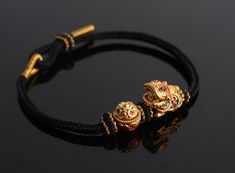 A 24k Real Gold Bracelet with a traditional Chinese lion-dance and treasure bowl is carefully handmade to commemorate wealth, fortune, strength, and good luck.  The Lion-Dance charm is made of 24K 999 Pure Gold and is 14mm wide, 16mm long, and 10.5mm high. Meanwhile, the Treasure Bowl charm has a diameter of 11.3 mm and a height of 11.1 mm, making a total gold weight of approximately 1.7 g.  This minimalist style bracelet features a handmade hand braided bracelet cord that is adjustable to fit comfortably on any wrist. The bracelet is personalized and made to order, making it a unique gift or addition to any jewelry collection. This Fengshui bracelet is 24k gold and is not gold-plated nor gold-filled. It is also a Made to Order item, and a wide range of sizes are available for customers wo Real Gold Bracelet, Chinese Lion Dance, Chinese Lion, Bracelet Cord, Gold Lion, Lion Dance, Lucky Bracelet, Braided Bracelet, Braided Bracelets