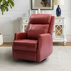 a red leather recliner chair in a living room with a white rug on the floor