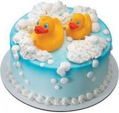 a blue cake with two yellow rubber ducks in it