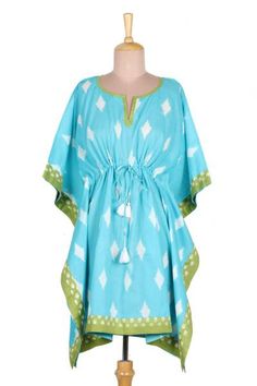 Keep yourself cool on summer days wearing this breezy caftan designed by Indian artisan Aftab. Hand crafted from cool comfortable cotton the caftan features a white diamond pattern on a turquoise base. The artisan adds a beaded drawstring tassel that cinches at the waist and pretty sap green trim. Green Relaxed Fit Tunic For Summer, Blue Summer Kaftan For Loungewear, Green Short Sleeve Kaftan For Spring, Blue Cotton Kaftan For Loungewear, Blue Cotton Kaftan For The Beach, Summer Ikat Print Kaftan For Beach, Blue Cotton Kaftan For Vacation, Green Casual Tunic Kaftan, Blue Cotton Kaftan For Beachwear