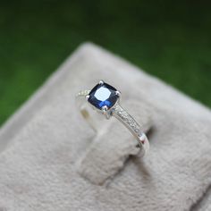 * Material: 925 Sterling Silver * DETAILS ✥ Handmade Ring ✥ - Center Stone: Lab Blue Sapphire  - Center Stone Size: 6 MM - Center Stone Shape: Cushion  - Side Stone: CZ Diamond  ✥ O T H E R ∙ I N F O R M A T I ON ✥ ♦ Your item will be nicely packed to gift in elegant jewelry boxes. ♦ Custom Order We can make custom rings in almost any shape and style. If you want a specific model, please send us a clear picture and we will do our best. ♦ Delivery All Item will be Shipped within 3 to 5 Days after Sapphire Cubic Zirconia Ring With Halo Setting For Gift, Gift Sapphire Ring With Halo Setting And Cubic Zirconia, Gift Sapphire Ring With Halo Setting, Silver Sapphire Ring In Princess Cut, Sapphire Gemstone Diamond Ring In Sterling Silver, Princess Cut Sapphire Ring In Sterling Silver, Fine Jewelry Gift With Lab-created Sapphire Center Stone, Cubic Zirconia Sapphire Ring With Accent Stones As Gift, Cubic Zirconia Sapphire Ring With Center Stone As Gift