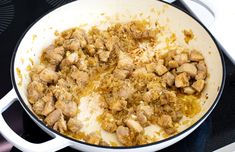 a pan filled with food sitting on top of a stovetop next to a burner