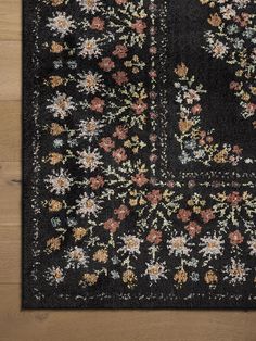 a black rug with flowers on it