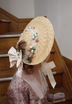 Regency style low crown straw hat with turned up brim in the back, accented with ivory double bow, feather, tulle and small flowers. Satin ribbons are at the sides which can tie under the chin. Spring Straw Boater Hat With Bow, Spring Curved Brim Boater Hat With Bow, Brimmed Boater Hat With Ribbon For Garden Party, Brimmed Straw Hat With Ribbon For Garden Party, Spring Boater Hat With Bow And Curved Brim, Spring Boater Hat With Curved Brim And Bow, Curved Brim Boater Hat With Ribbon For Garden Party, Brimmed Boater Hat With Bow For Garden Party, Adjustable Straw Hat With Ribbon For Garden Party