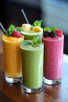 Four colorful smoothies garnished with fresh fruit and mint leaves in tall glasses on a wooden table. Fruits Juice Recipes, Juice And Smoothie Recipes, Smoothie Recipes For Diabetics, Refreshment Drinks, Healthy Delicious Smoothies, Healthy Smoothies For Breakfast, Pineapple Banana Smoothie, Healthy Alcoholic Drinks