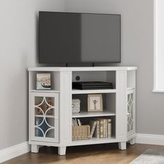 a flat screen tv sitting on top of a white entertainment center