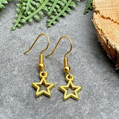 Small charm bead earrings with gold plated hollow star charms.Total length including hooks is 31mm (1.2 inches), charms measure 9mm (0.35 inches) across. Silver tone hooks comply with strict regulations for nickel and lead content in jewellery.Lightweight, allergy friendly, comfortable and easy to wear every day. Comes in a pretty organza bag, ready to give away. Other designs available in our Handmade store. Very pretty bead earrings for everyday use! Our items are handmade with love, and make Star-shaped Earrings With Lever Back For Gifts, Gold Star-shaped Earrings With Ear Wire, Gold Star Earrings With Ear Wire, Gold Star Jewelry For Christmas, Gold Star Charm Metal Earrings, Metal Earrings With Star Charm For Gift, Hypoallergenic Star-shaped Metal Earrings, Hypoallergenic Star-shaped Metal Jewelry, Star-shaped Metal Earrings For Gifts