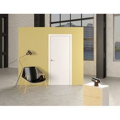 an empty room with yellow walls and a black chair next to the door that is open