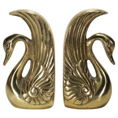 pair of brass swan bookends on white background