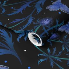 a black wallpaper with blue flowers and butterflies on it's side, next to a circular hole in the middle