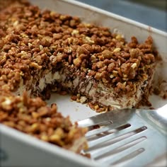 a close up of a cake in a pan with a fork