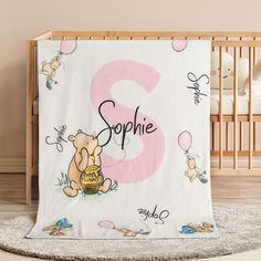 a baby crib with a winnie the pooh blanket on it