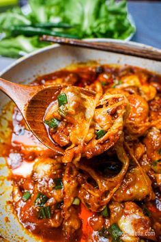 a wooden spoon is full of food in a bowl