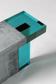 a concrete block with a green square in the middle and a black square at the end