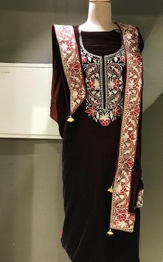 A stunningly marvellous velvet dress. This suit features intricate zari/tilla embroidery on the shirt neck, on sleeves and 4 sided embroidered border on the dupatta.- - - - - - - - - - - - - - - - - - - - Product Details- Condition Brand New - Dupatta Size: 88" X 38" (225 cms X 96.52 cms) approx.- Colour: MarronF A B R I CShirt: VelvetDupatta: VelvetBottom: Velvet or Indian Crepe (whichever you prefer, let us know.)F I N I S HUnstitched/Semi-StitchedYou can get it stitched locally.47+ inches of Navratri Velvet Dupatta Traditional Drape, Elegant Embroidered Velvet Dress, Festive Velvet Straight Kurta, Diwali Velvet Kurta With Mirror Work, Semi-stitched Traditional Velvet Dress, Semi-stitched Velvet Traditional Dress, Designer Velvet Kurta With Mirror Work, Festive Velvet Salwar Kameez With Mirror Work, Designer Velvet Kurta For Diwali