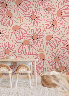 two children's chairs in front of a wall with pink and orange flowers on it