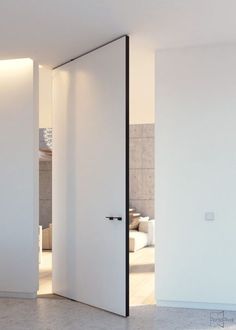 an open door leading to a bedroom with white walls and flooring in the background