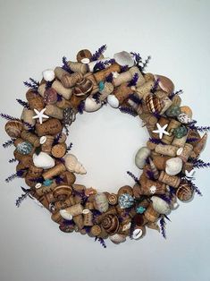 a wreath made out of wine corks and seashells on a white wall