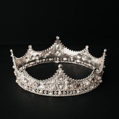 Cecily's crown features pearl and crystal details set into silver colored metal perfect for any special occasion.  Crown circumference = 21 Inches Max Height = 2.2 Inches Min Height = 1 Inch Distance Peak to Peak = 2.5 inches Crown is a solid circle and cannot be widened or narrowed in circumference.  Crown features loops to attach to hair. Item ships from Michigan, USA. WARNING: CHOKING HAZARD This is not a toy.  This item is not intended for use by children under the age of 5 years old.  There are small pieces that could fall off and create a choking hazard.  All use of this product by any minor, child or dependent should be supervised by an adult 18 years of age or older. Silver Crown Aesthetic, Full Circle Crown, Silver Crowns, Real Crown, Glass Crown, Royalty Crown, Fantasy Crown, Small Crown, Crown Aesthetic