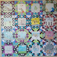 a quilt made with many different colored squares and pictures on it's side wall