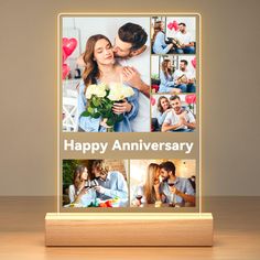 an illuminated photo frame with the words happy anniversary on it and pictures of two people kissing each other