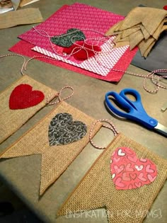 several pieces of burlap with hearts on them and scissors next to each other