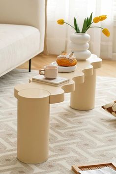 a coffee table with two vases on it and some food in front of it