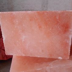 two pieces of pink soap sitting on top of each other