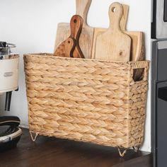 a basket with cutting boards and knives in it on a counter next to an oven