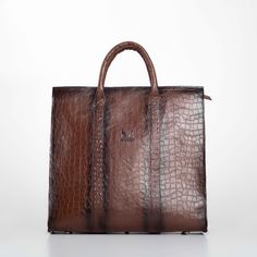 Elevate your professional ensemble with our Handmade Brown Leather Business XL Bag, a perfect blend of luxury and functionality for the modern man. Expertly crafted from premium genuine leather, this bag features an elegant embossed pattern that exudes sophistication. The interior is lined with durable gabardine fabric, while sleek black nickel metallic elements add a contemporary touch. Designed with practicality in mind, this spacious bag includes an internal zippered pocket, a dedicated laptop compartment, and a leather mobile phone holder, ensuring all your essentials are organized and secure. The long, adjustable strap with broad padding offers comfort, making it ideal for daily business use or travel. Key Features: Sophisticated Design: Crafted from high-quality genuine leather with High-end Brown Top Handle Briefcase, High-end Brown Briefcase With Top Handle, Designer Formal Bags With Large Capacity, Designer Large Capacity Formal Bags, Designer Business Tote Shoulder Bag, Designer Tote Shoulder Bag For Business, High-end Business Bags, High-end Business Bags With Top Carry Handle, Luxury Briefcase With Large Capacity And Top Handle