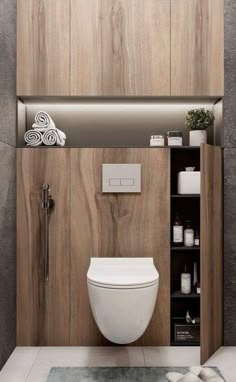 a modern bathroom with wood paneled walls and white fixtures, including a toilet in the center