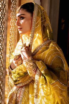 a woman in a yellow and gold outfit