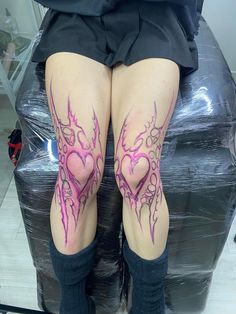 a woman's legs with tattoos on them and her leg in the shape of a heart