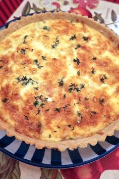 a quiche is sitting on a blue and white plate