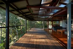 an outdoor covered deck with chairs and tables