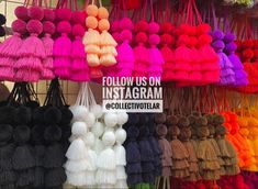 many different colors of tassels hanging from hooks