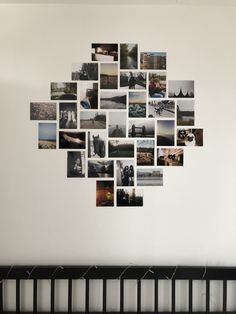 a white wall with many pictures hanging on it's side and a crib in the foreground