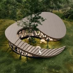 an aerial view of a circular structure in the middle of a grassy area with stairs leading up to it